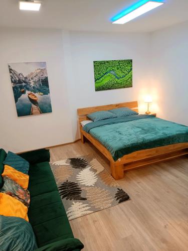a bedroom with a bed and a couch at Apartments Romantic and Family Room Zemlinski in Payerbach