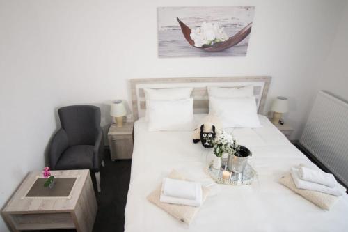 a bedroom with a bed with a table and a chair at Aparthotel "Queen Zina" in Vlasic