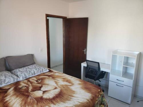 a bedroom with a lion blanket on a bed at espaço especial em SJP in São José dos Pinhais