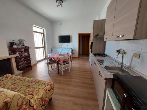 a kitchen with a sink and a living room at Villa Marusia in Tollo