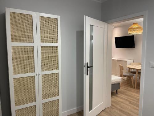 a room with white doors and a room with a table at Port Rewa in Rewa
