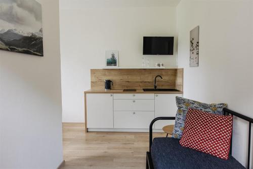 a living room with a sink and a couch at Chalupa Bezvětří in Malá Morávka