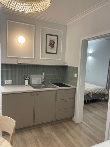 a kitchen with a sink and a bed in a room at Port Rewa in Rewa