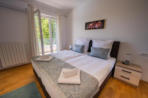 a bedroom with a large bed with two pillows on it at Villa Tonka in Nova Vas