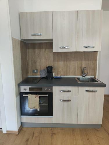 a kitchen with a sink and a stove at Casa CHANEL in Latina