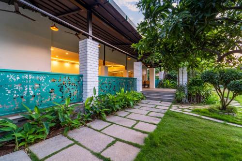 a house with a garden and a walkway at Palette - Coastal Grand Hotels & Resorts, OMR in Chennai