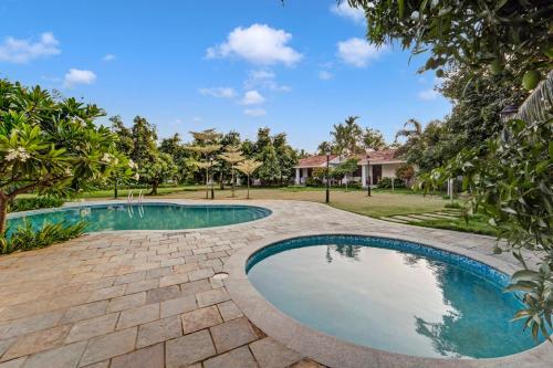 an image of a swimming pool in a yard at Palette - Coastal Grand Hotels & Resorts, OMR in Chennai