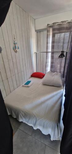 a bedroom with a bed with a book on it at Canapé lit "appartement partagé" en centre ville in Annemasse