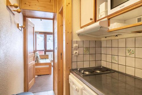 Il comprend une cuisine équipée d'un évier et d'une cuisinière. dans l'établissement Résidence Le France - Studio 2 pers - LE FRANCE - PLAGNE CENTRE MAE-9584, à Aime La Plagne