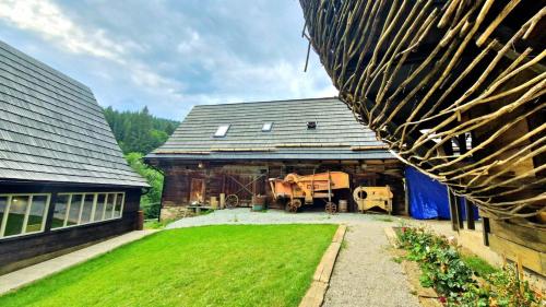 a barn with a truck parked inside of it at Chalúpky Zázrivá in Zázrivá