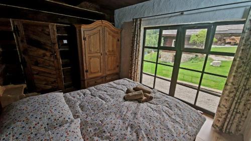 a bedroom with a bed with a teddy bear on it at Chalúpky Zázrivá in Zázrivá