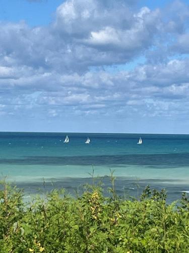 three sailboats in the ocean on a cloudy day at Drift in Goderich