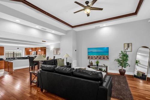 a living room with a couch and a ceiling fan at Enchanted 4BR Family Style Townhome in Disney Area in Orlando