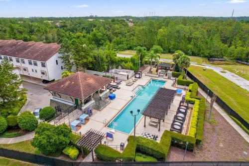 an aerial view of a home with a swimming pool at Enchanted 4BR Family Style Townhome in Disney Area in Orlando