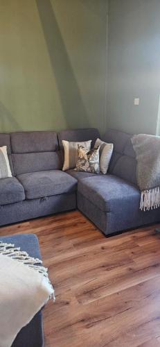 a living room with a couch with pillows on it at Mount Bolton Loft House in Portlaw