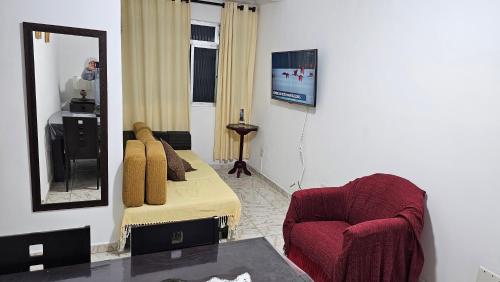 Habitación con cama, espejo y silla. en Miami Beach, en Praia Grande