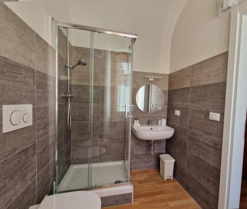 a bathroom with a shower and a sink at Piazza Cavour in LʼAquila