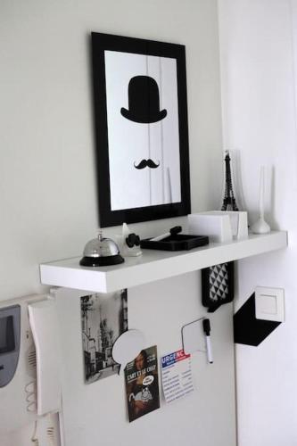 a white shelf with a picture of a man with a top hat at RER C Les Grésillons NEAR PARIS in Asnières-sur-Seine
