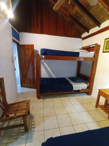 a room with two bunk beds and a chair at Hotel SoleMare in Montañita