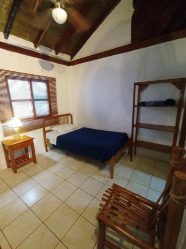 a bedroom with a blue bed in a room at Hotel SoleMare in Montañita