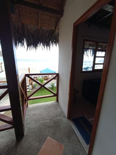 a door to a room with a view of the beach at Hotel SoleMare in Montañita