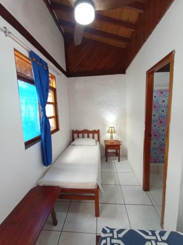 a small bedroom with a bed and a window at Hotel SoleMare in Montañita