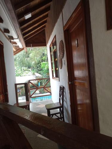 a room with a door and a chair and a balcony at Hotel SoleMare in Montañita