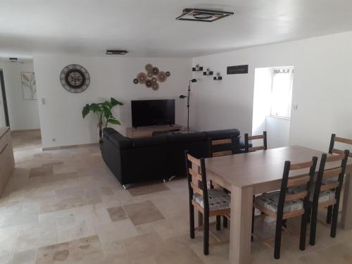 un salon avec une table et un canapé dans l'établissement Maison Périgord, à Saint-Cernin-de-lʼHerm