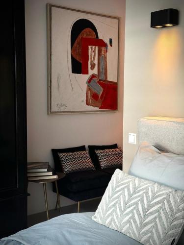 a bedroom with a bed and a couch at B&B Urban Oasis with Free Parking in Amsterdam