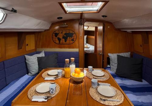 a wooden table with plates and food on it at Velero Puma 32 in Caleta de Sebo