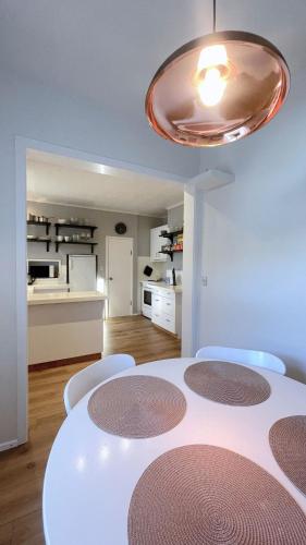 a dining room with a white table and chairs at Private Retreat by Arctic Circle in Húsavík