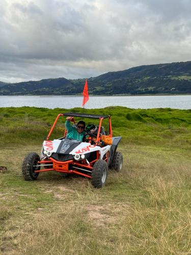 a couple of people in a four wheeler in a field at Nature Luxury Glamping in Guatavita