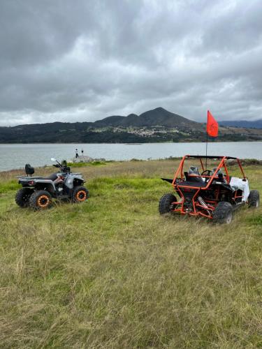 two atvs and a four wheeler parked in a field at Nature Luxury Glamping in Guatavita