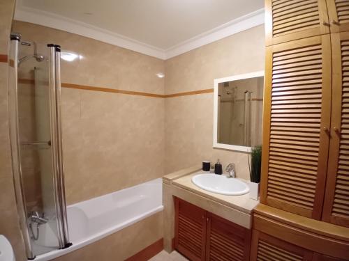 a bathroom with a sink and a shower and a tub at Lisbon Blue - Metro at your Door in Lisbon