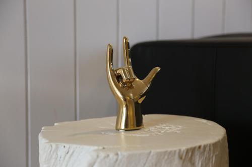 a gold hand statue sitting on top of a table at Private Retreat by Arctic Circle in Húsavík