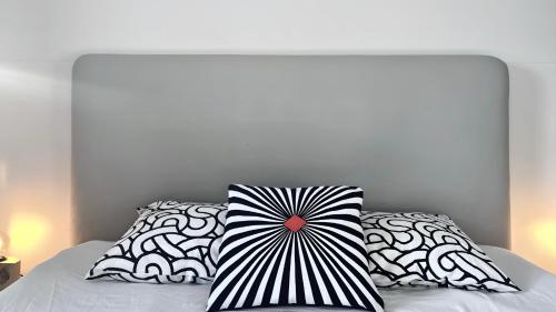 a bed with two black and white pillows on it at Private Retreat by Arctic Circle in Húsavík