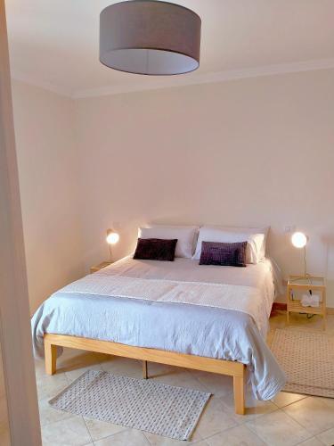 a bedroom with a large bed with two pillows at Bolsena Cento20 - Rooms & Relax in Bolsena