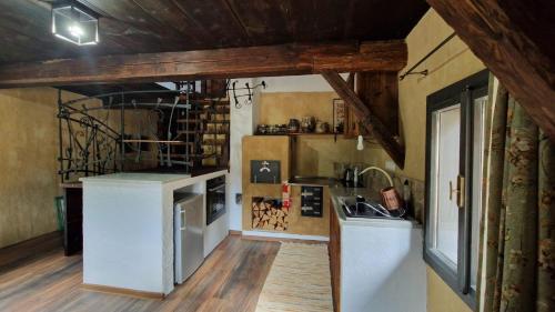 a kitchen with a counter and a sink in a room at Chalúpky Zázrivá in Zázrivá