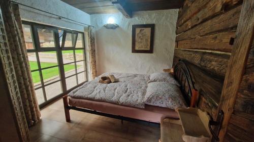 a bedroom with a bed with a cat laying on it at Chalúpky Zázrivá in Zázrivá