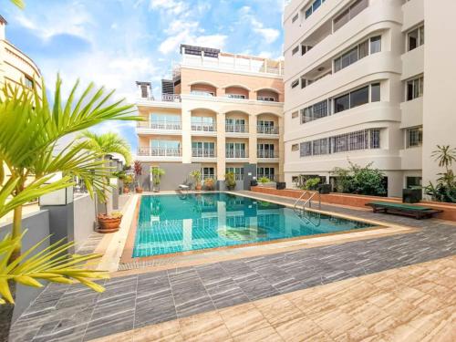 a swimming pool in front of a building at Luxury beach studio 9 floor in Pattaya