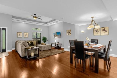 a living room with a table and a dining room at Vibrant 4BR Family Townhome 1 mile from Disney World and Disney Springs in Orlando