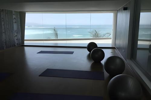 a room with a ping pong table and a large window at Condominio Ocean reef in San Bartolo