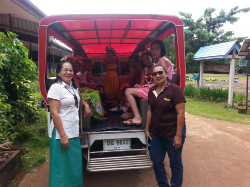 a man and two women standing in front of a truck at Happy Days Resort in Ko Mak