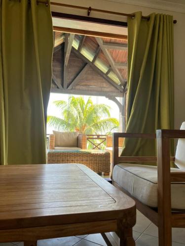 a room with a table and a chair and a window at Sunset Boulevard, Grand Baie in Grand Baie