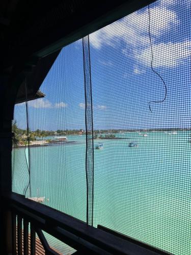 a view of a body of water from a window at Sunset Boulevard, Grand Baie in Grand Baie