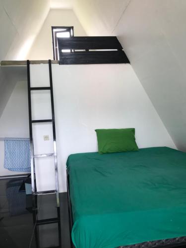 a bedroom with a bunk bed and a ladder at Rinjani Eger Bungalow in Sembalun Lawang