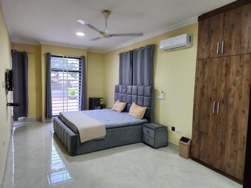 a bedroom with a bed and a ceiling fan at 2 bedroom Jab Villa in Adentan