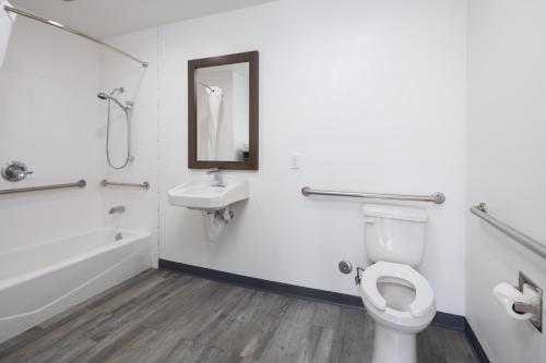 a bathroom with a toilet and a sink at Days Inn by Wyndham Arroyo Grande Pismo Beach in Arroyo Grande