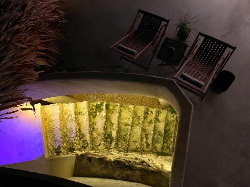 a bed in a room with a purple light at Elmar Hostel in Bacalar