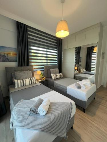 Ένα ή περισσότερα κρεβάτια σε δωμάτιο στο HG Mare Suites